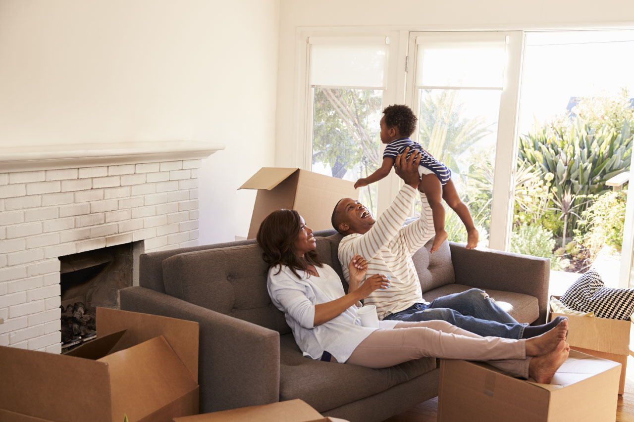 coulple with their child at her new home